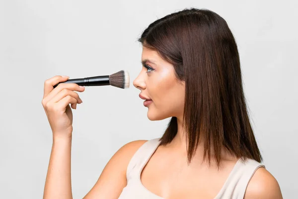 Young Russian Woman Isolated White Background Holding Makeup Brush — Stockfoto