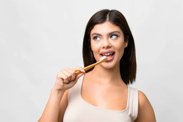 stock image Young Russian woman over isolated white background with a toothbrush