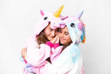 Friends girls with unicorn pajamas over isolated white background