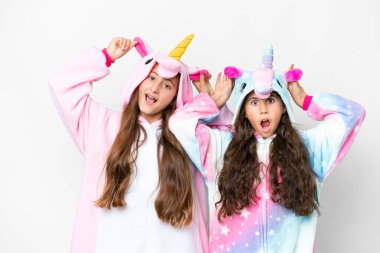 Friends girls with unicorn pajamas over isolated white background