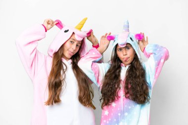 Friends girls with unicorn pajamas over isolated white background