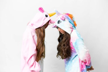 Friends girls with unicorn pajamas over isolated white background