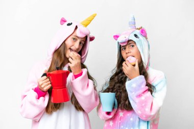 Friends girls with unicorn pajamas over isolated white background