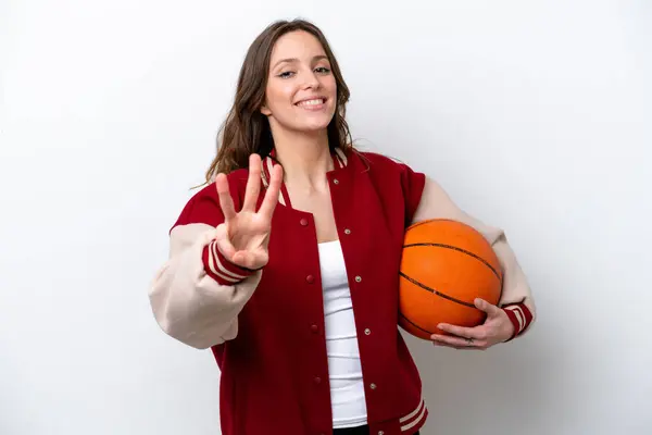 若いですCaucasian女性プレイバスケットボール孤立した上に白の背景幸せとカウント3とともに指 — ストック写真
