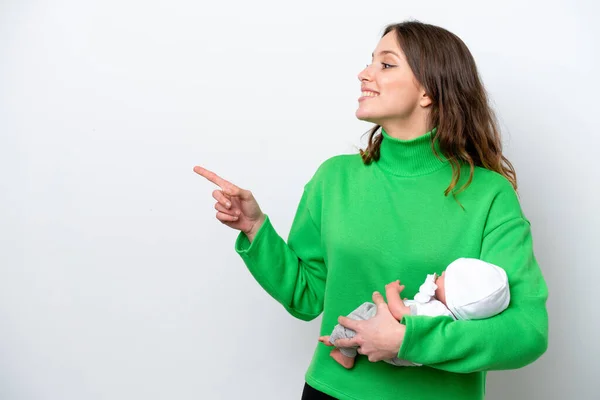 Young Caucasian Woman Her Cute Baby Isolated White Background Pointing — Fotografia de Stock