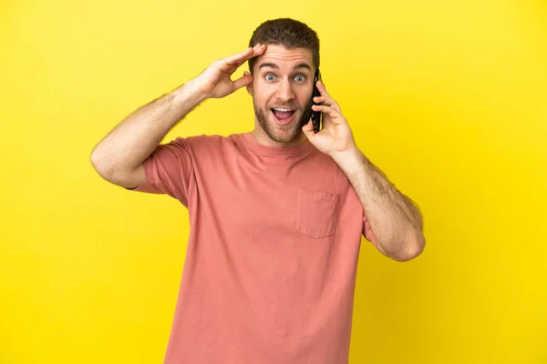 Handsome Blonde Man Using Mobile Phone Isolated Background Surprise Expression — Stock Photo, Image