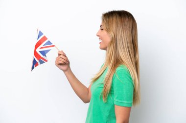 Young Uruguayan woman holding an United Kingdom flag isolated on white background with happy expression
