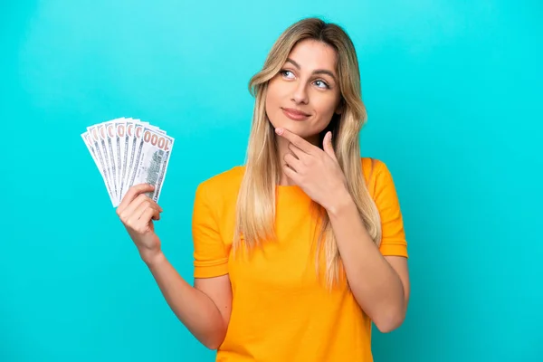 Young Uruguayan Woman Taking Lot Money Isolated Blue Background Having — Stock fotografie