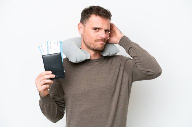 Young caucasian man holding a passport isolated on white background having doubts