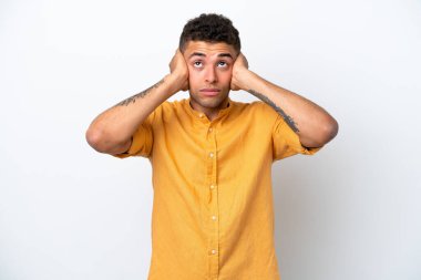 Young caucasian Brazilian man isolated on white background frustrated and covering ears