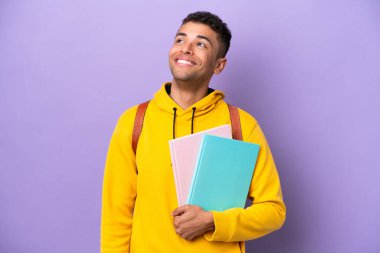 Young student Brazilian man isolated on purple background thinking an idea while looking up