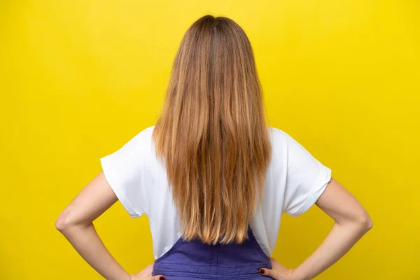Young Caucasian Woman Isolated Yellow Background Back Position — Stock Photo, Image