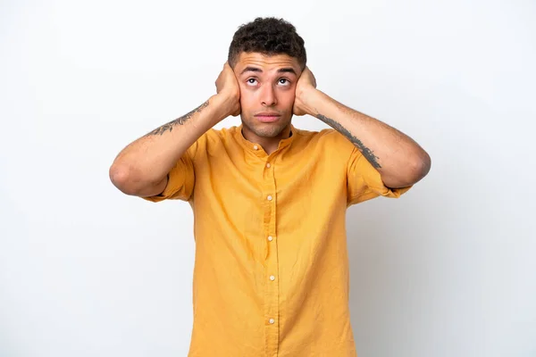 Stock image Young caucasian Brazilian man isolated on white background frustrated and covering ears