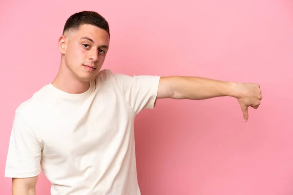Young Brazilian Man Isolated Pink Background Showing Thumb Negative Expression — Stock Photo, Image