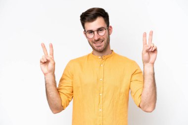 Young caucasian man isolated on white background showing victory sign with both hands