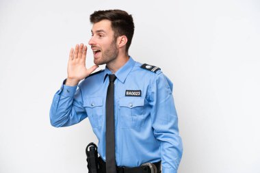 Young police caucasian man isolated on white background shouting with mouth wide open to the lateral