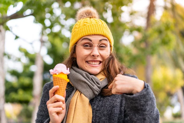 Stock image Brunette woman with a cornet ice cream at outdoors with surprise facial expression