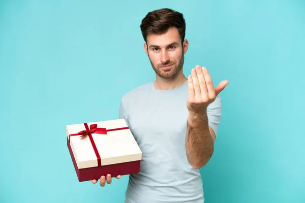 Young Caucasian Man Holding Gift Isolated Blue Background Inviting Come — Stock Photo, Image
