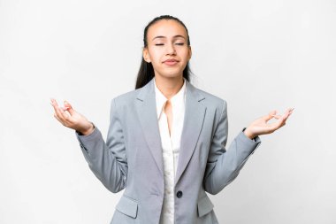 Zen pozunda soyutlanmış beyaz arka planı olan genç bir Arap kadın.