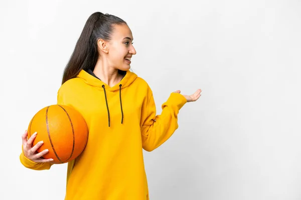 年轻的阿拉伯女子在与世隔绝的白色背景上打篮球 她面带微笑地看着旁边 — 图库照片