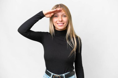 Young pretty blonde woman over isolated white background saluting with hand with happy expression