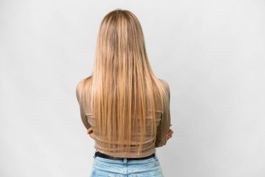 Young pretty blonde woman over isolated white background in back position