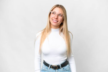 Young pretty blonde woman over isolated white background thinking an idea while looking up