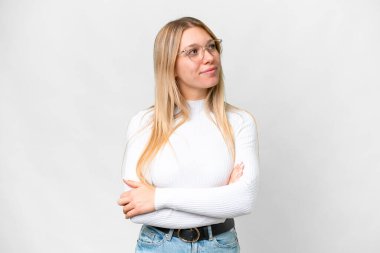 Young pretty blonde woman over isolated white background looking to the side