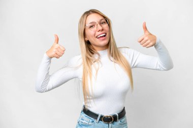 Young pretty blonde woman over isolated white background giving a thumbs up gesture