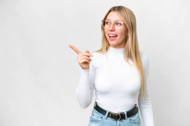 Young pretty blonde woman over isolated white background intending to realizes the solution while lifting a finger up