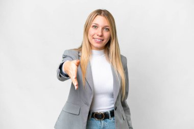 Young pretty blonde woman over isolated white background shaking hands for closing a good deal