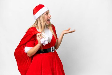 Young blonde woman with christmas hat over isolated white background with surprise facial expression