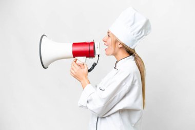 Young chef woman over isolated white background shouting through a megaphone