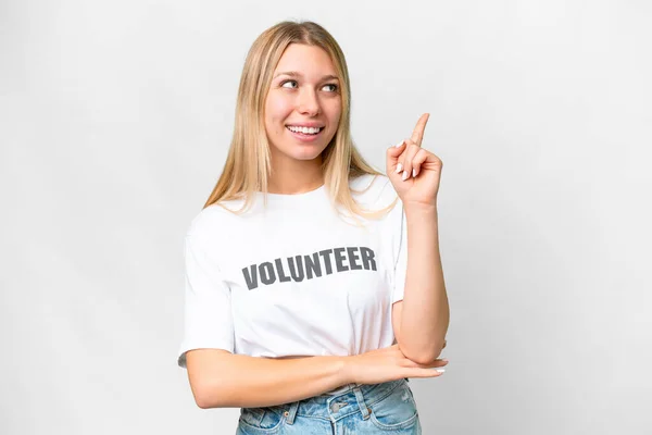 stock image Young volunteer woman over isolated white background pointing up a great idea