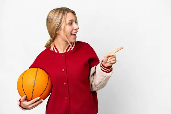 Mladá Blondýnka Hraje Basketbal Přes Izolované Pozadí Ukazující Prstem Stranu — Stock fotografie