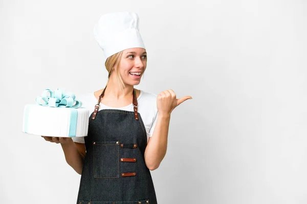Young Pastry Blonde Woman Big Cake Isolated White Background Pointing — Stock fotografie
