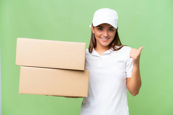 Delivery Caucasian Woman Holding Boxes Isolated Green Chroma Background Pointing — Zdjęcie stockowe