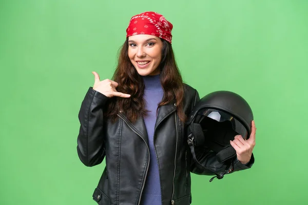 携帯電話のジェスチャーを作る孤立した背景の上にオートバイのヘルメットを持つ若い白人女性 サインを呼んでくれ — ストック写真