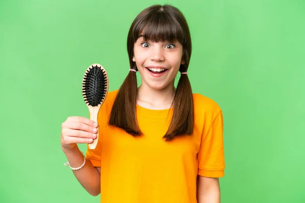 Little caucasian girl with hair comb over isolated background with surprise and shocked facial expression