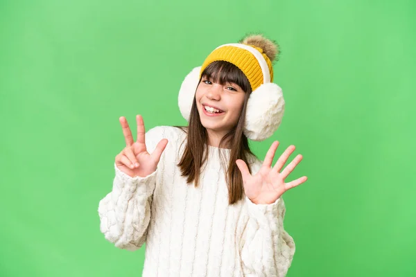Little Caucasian Girl Wearing Winter Muffs Isolated Background Counting Eight — Stock Photo, Image