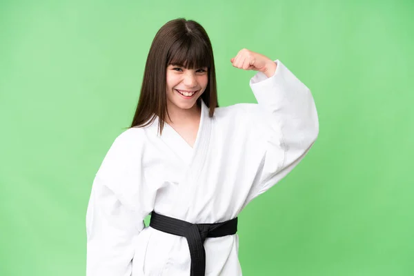 stock image Little Caucasian girl doing karate over isolated background doing strong gesture