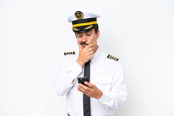 stock image Airplane caucasian pilot isolated on white background thinking and sending a message