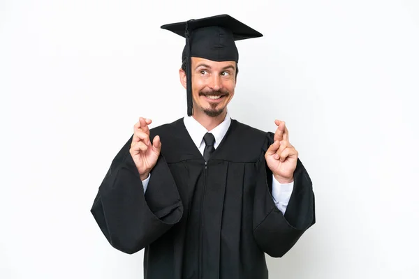 Jonge Universiteit Afgestudeerde Man Geïsoleerd Witte Achtergrond Met Vingers Kruisen — Stockfoto