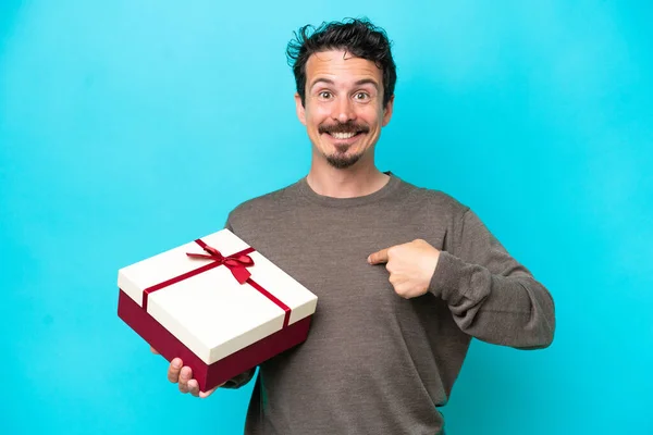 Young Man Holding Gift Surprise Facial Expression — Zdjęcie stockowe