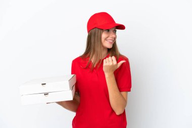 Pizza delivery Lithuanian woman isolated on white background pointing to the side to present a product