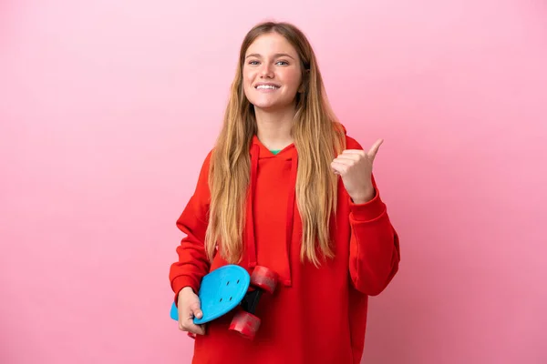 Junge Blonde Frau Isoliert Auf Rosa Hintergrund Mit Einem Skate — Stockfoto