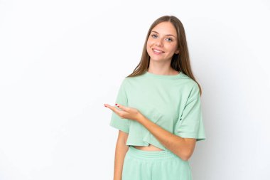 Young Lithuanian woman isolated on white background presenting an idea while looking smiling towards