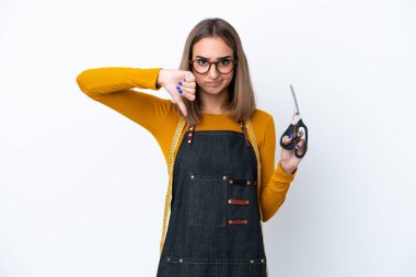 Young caucasian sewing box woman isolated on white background showing thumb down with negative expression