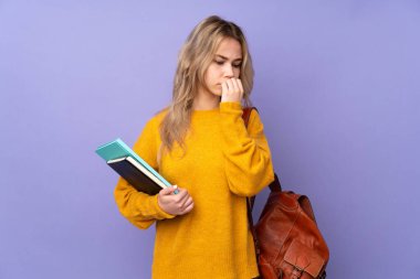 Teenager Russian student girl isolated on purple background having doubts