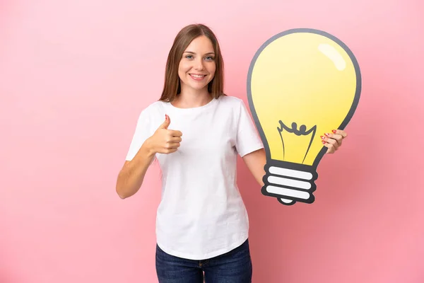 Young Lithuanian Woman Isolated Pink Background Holding Bulb Icon Thumb — Stock Photo, Image